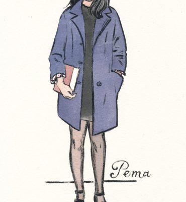 young lady holding a book dressed in a well-cut navy blue coat